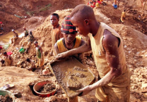 Congolese miners dig at a gold mine in Montgbawalu