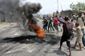 Demonstrators burn tyres to set up barricades during a protest in the Democratic Republic of Congo's capital Kinshasa